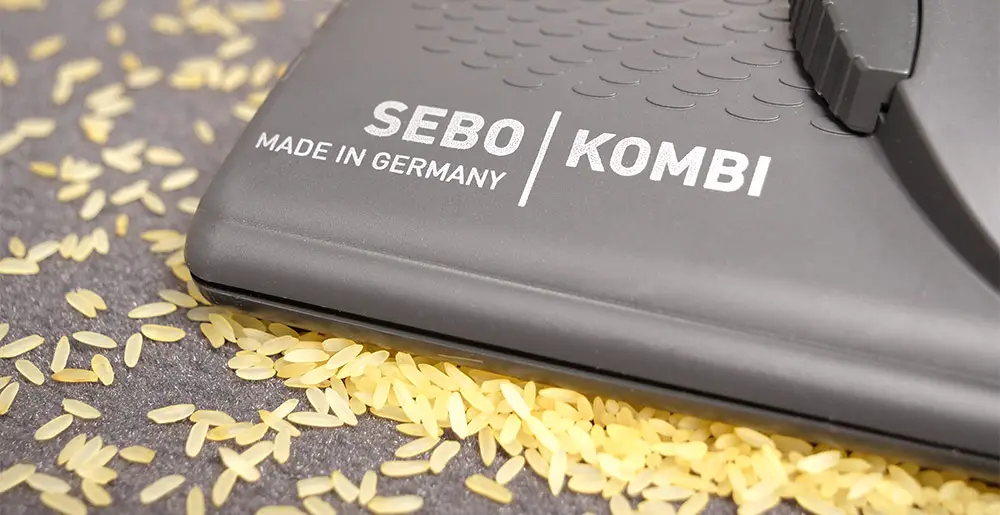 SEBO Airbelt E3 Komfort: Die SEBO KOMBI-Düse schließt an ihrer Spitze sehr nah am Fußboden ab. Dadurch sammeln sich vor allem Grobpartikel vor ihr an, sodass sich ein leichtes Anheben empfiehlt (im Bild: Reis).
